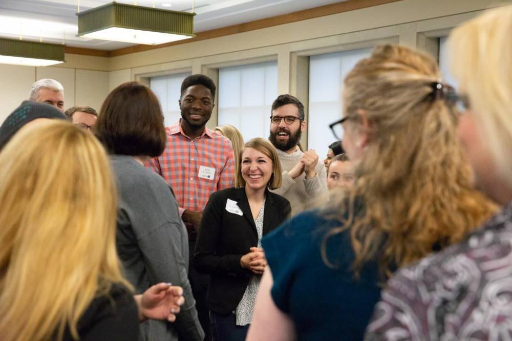 Alumni talk at a networking event.